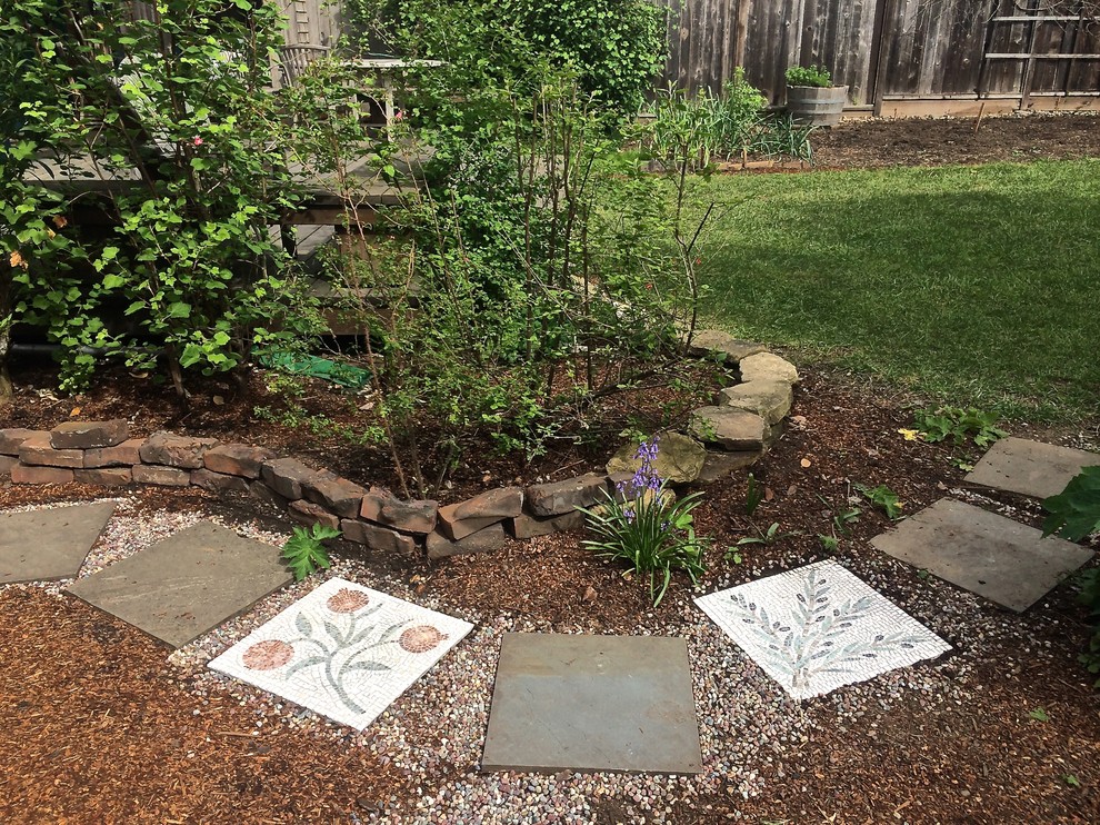 This is an example of a mid-sized mediterranean backyard concrete paver garden path in New York.