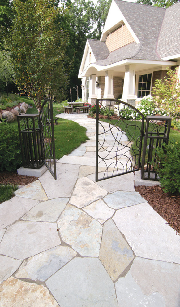 Inspiration for a large transitional front yard stone garden path in Minneapolis.