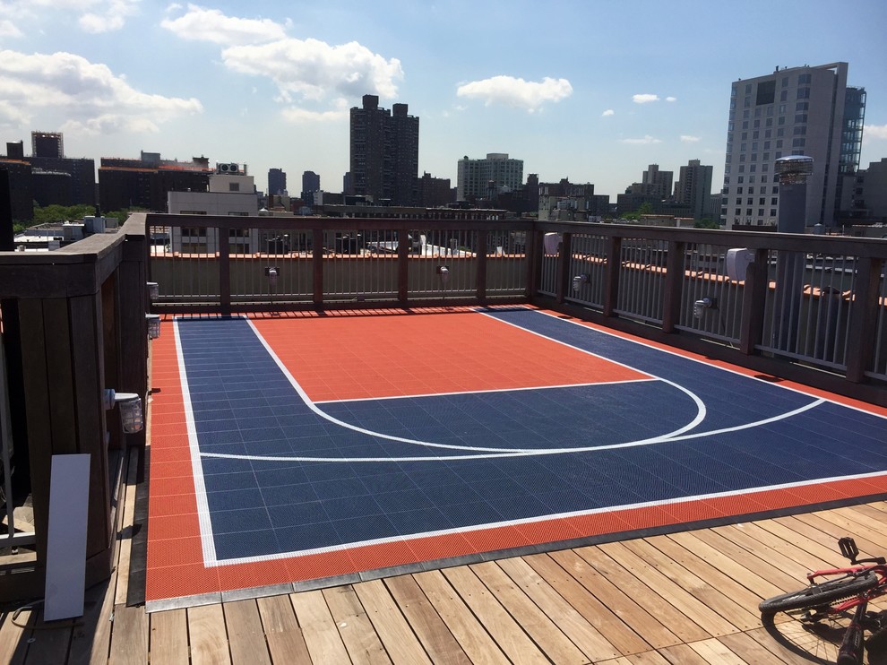 This is an example of a small roof full sun garden in New York with an outdoor sport court, a climbing frame and decking.