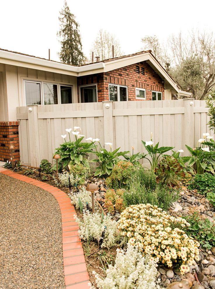 Classic xeriscape garden in San Francisco with lawn edging and decorative stones.