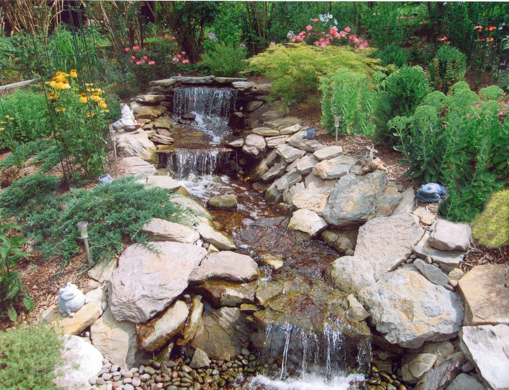 Photo of a large classic garden in New York with a water feature.