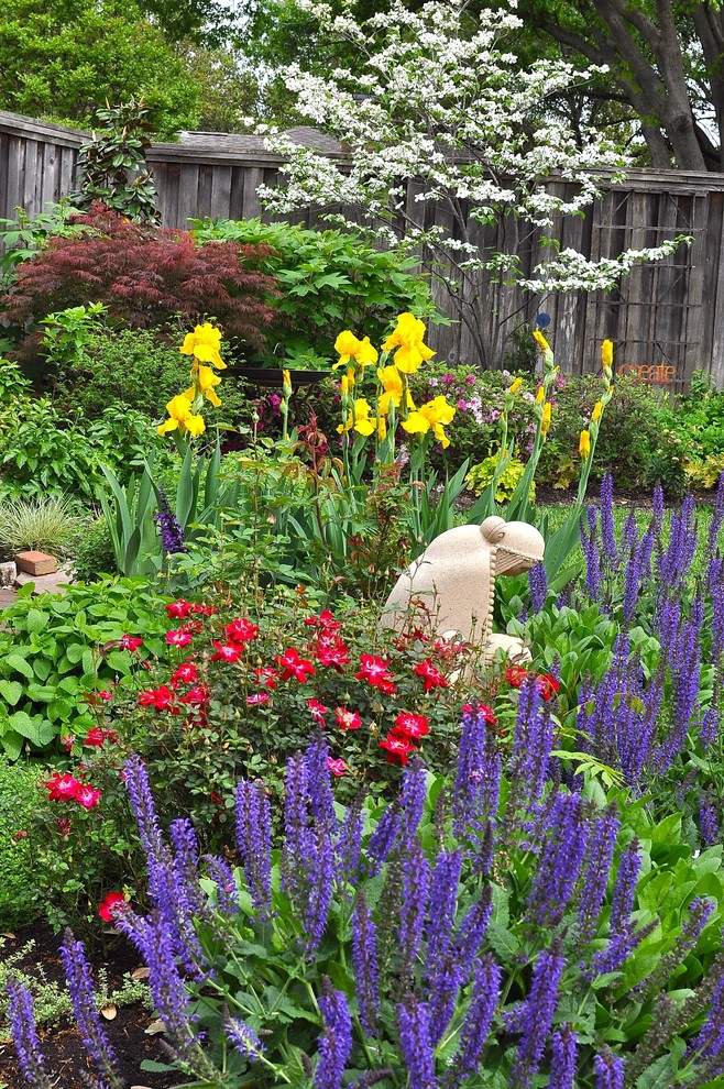 Cette photo montre un grand jardin arrière chic l'été avec une exposition partiellement ombragée, des pavés en pierre naturelle et une clôture en bois.