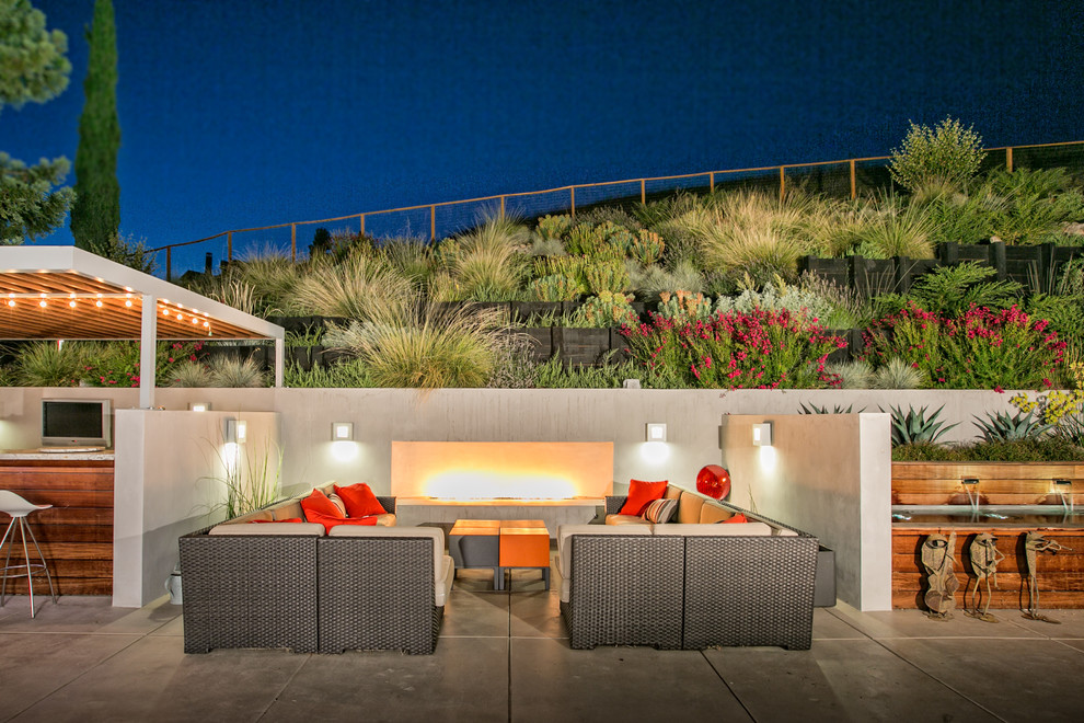 Contemporary sloped formal garden in San Francisco with a fire feature.