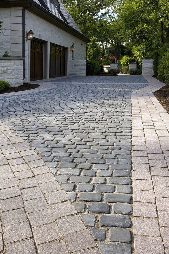 Design ideas for a large traditional front driveway full sun garden for summer in Chicago with concrete paving.