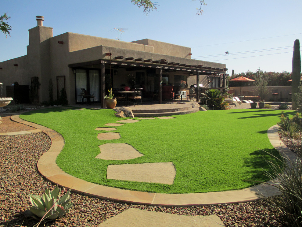 Design ideas for a large mediterranean drought-tolerant and full sun backyard lawn edging in Phoenix.