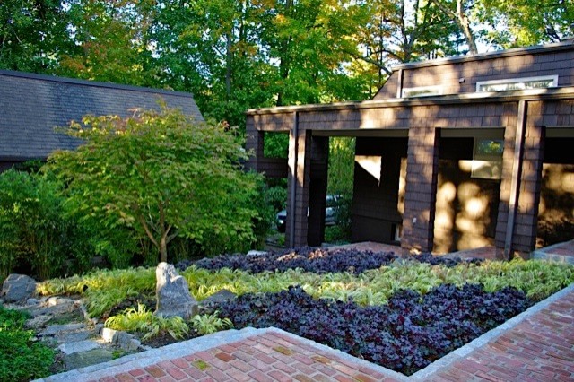 This is an example of a large contemporary partial sun courtyard brick landscaping in New York.