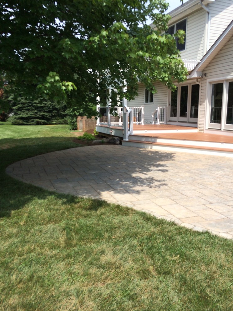Design ideas for a mid-sized transitional full sun backyard concrete paver landscaping in Baltimore.