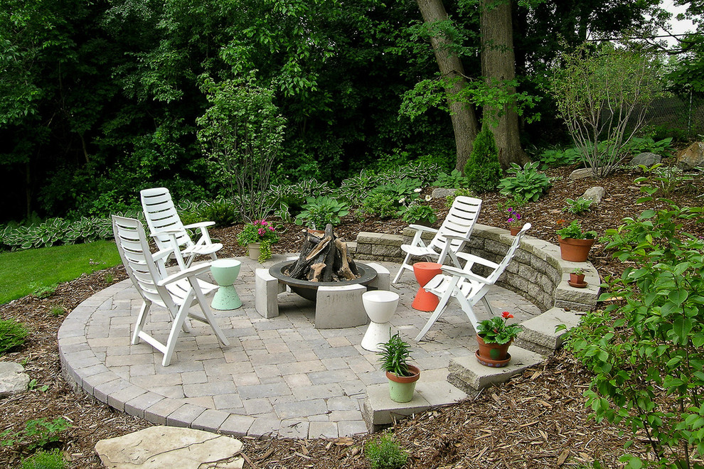 Photo of a large transitional backyard brick formal garden in Minneapolis with a fire pit.