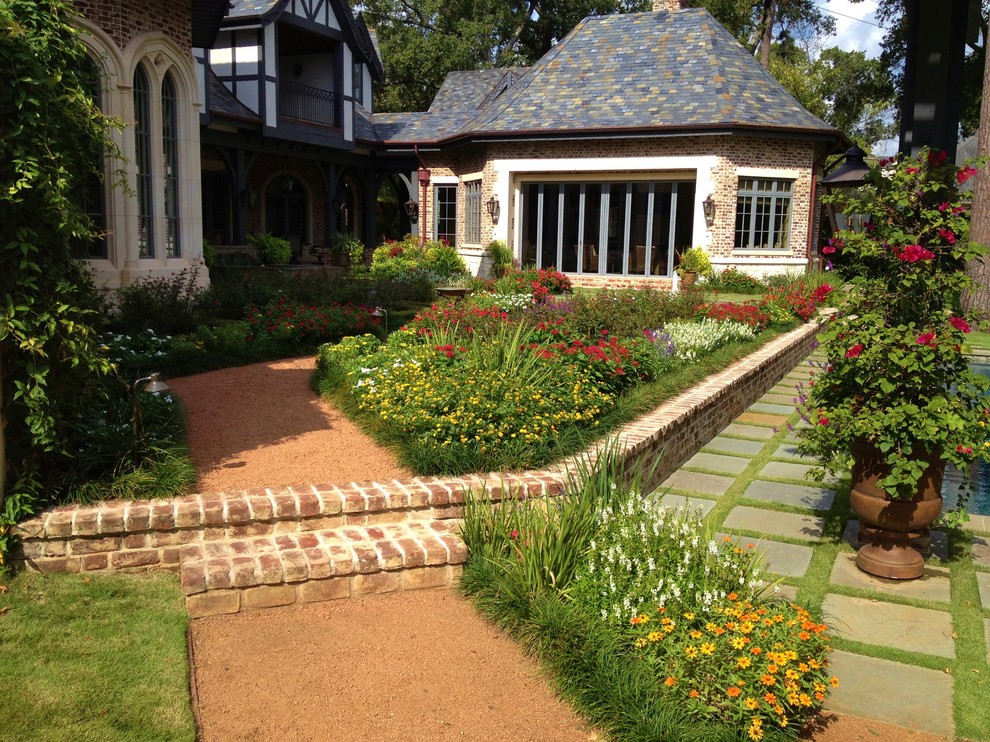 Inspiration for a large traditional back partial sun garden for spring in Houston with a water feature and natural stone paving.