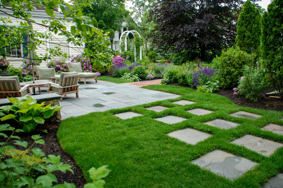 Inspiration for a mid-sized traditional full sun backyard stone formal garden in Boston.