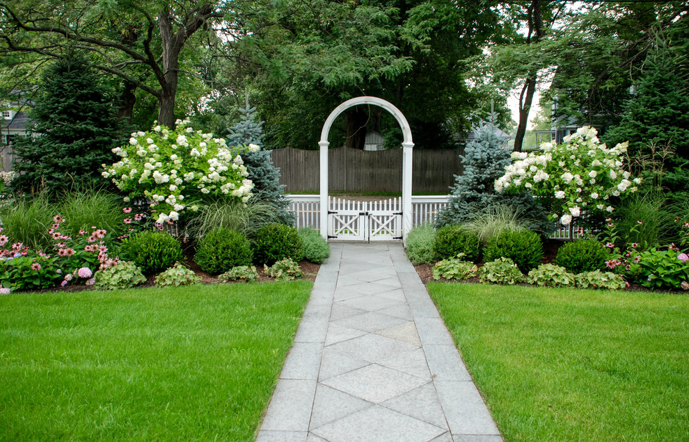 Design ideas for a mid-sized traditional full sun front yard stone formal garden in Boston.