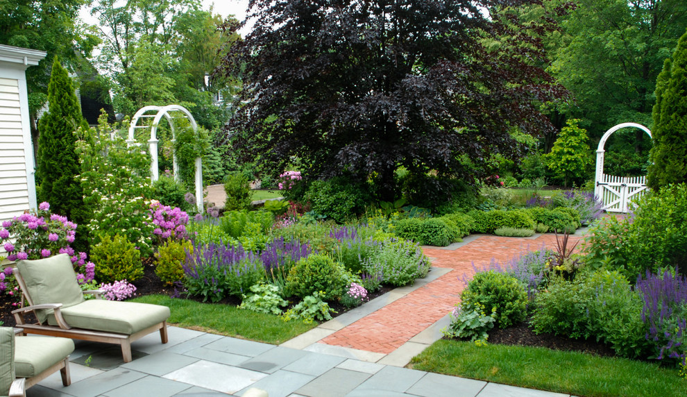 Medium sized traditional courtyard formal full sun garden in Boston with brick paving.