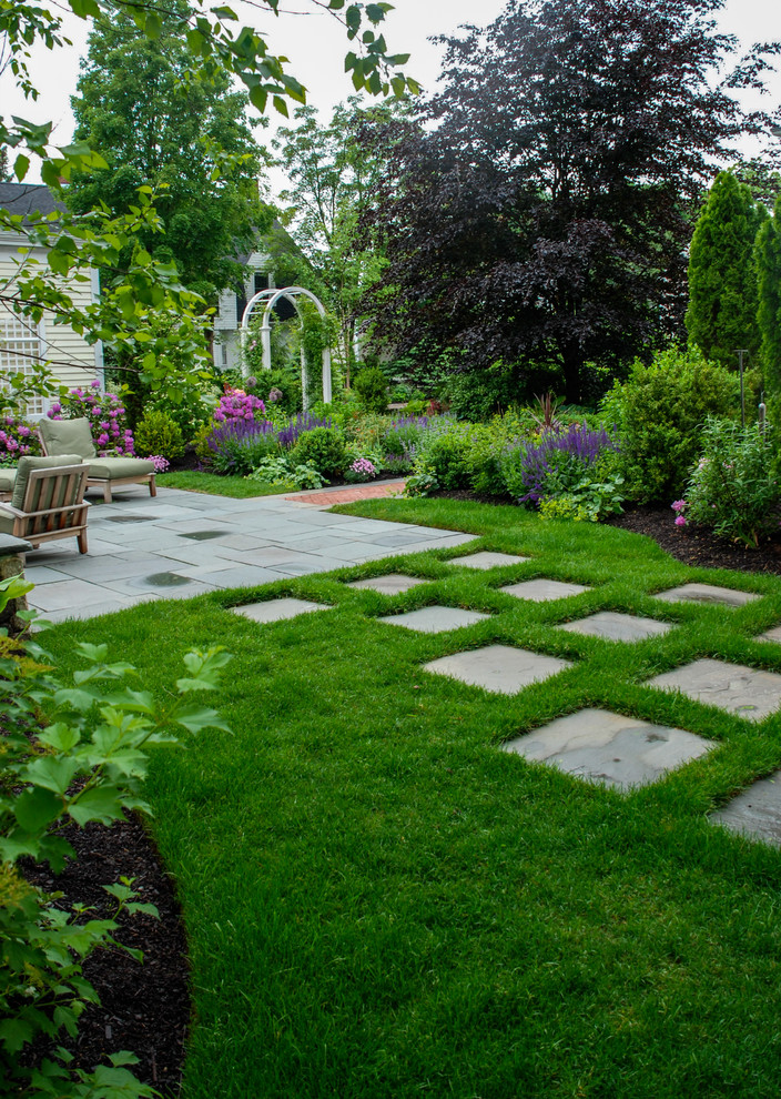 Ispirazione per un giardino classico esposto in pieno sole di medie dimensioni e dietro casa con pavimentazioni in pietra naturale