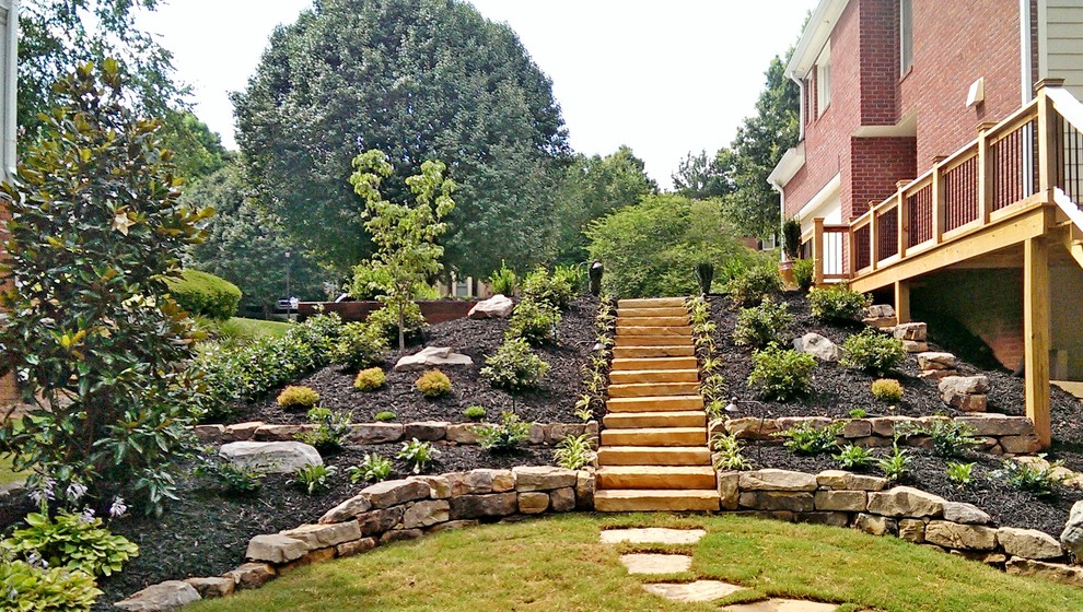 This is an example of a large traditional side yard stone landscaping in Atlanta.
