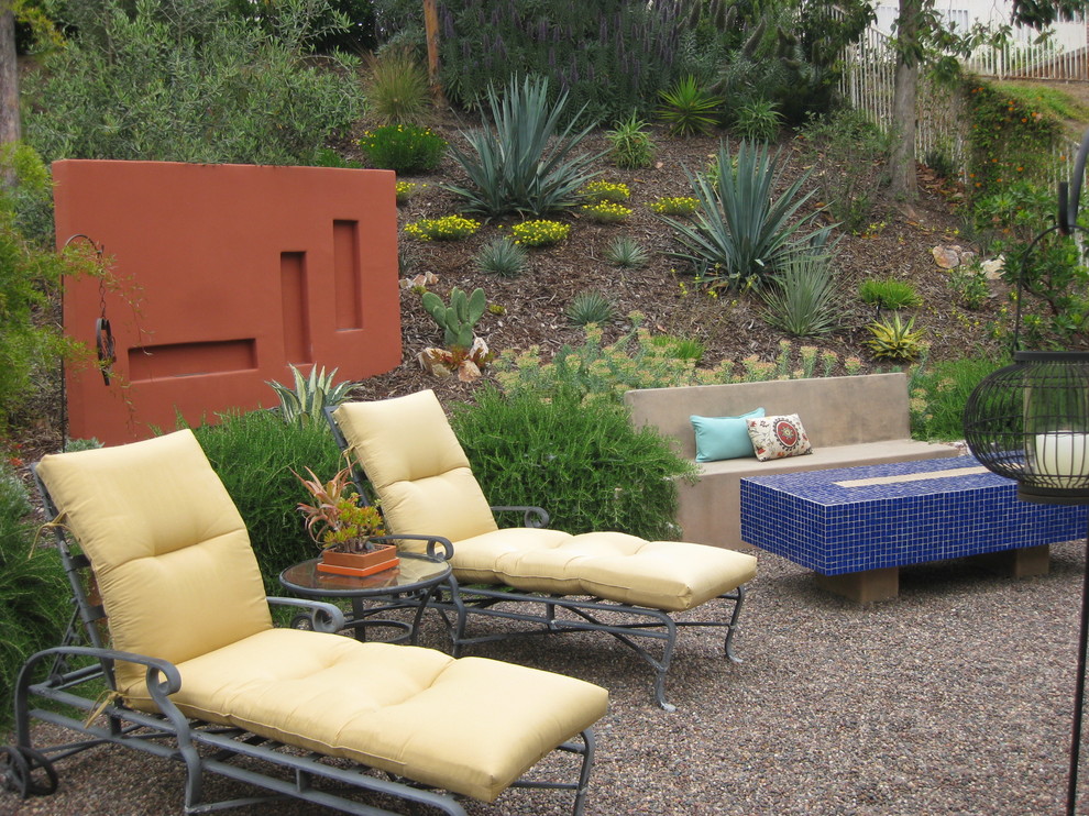 This is an example of a mediterranean back garden in San Diego with gravel.