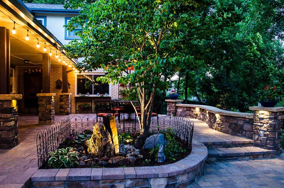 Photo of a traditional backyard stone water fountain landscape in Denver.