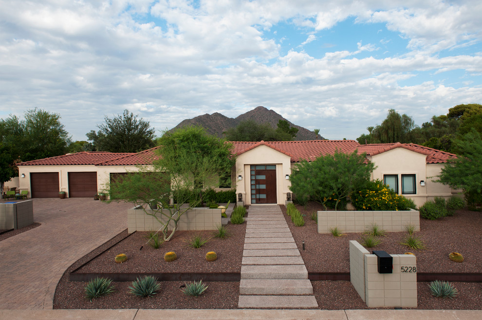 Design ideas for a large contemporary front xeriscape full sun garden in Phoenix with a garden path and concrete paving.