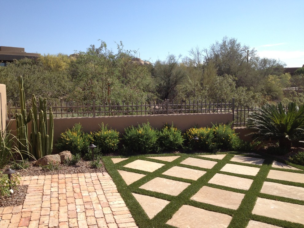 Inspiration for a mid-sized mediterranean backyard brick formal garden in Phoenix.