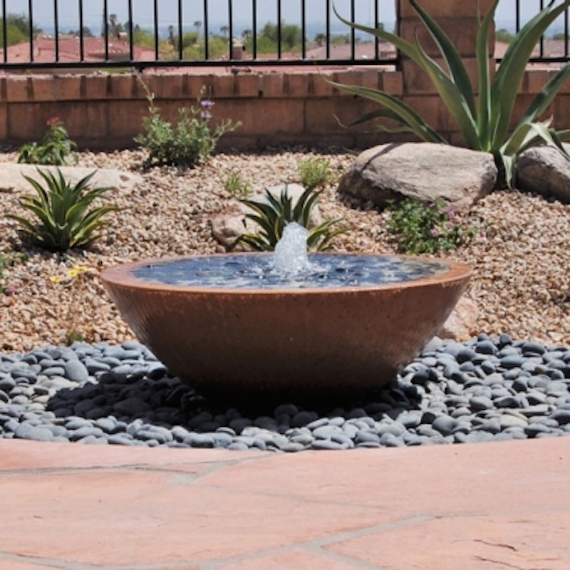 Inspiration for a large back xeriscape full sun garden for summer in Orange County with a water feature and natural stone paving.