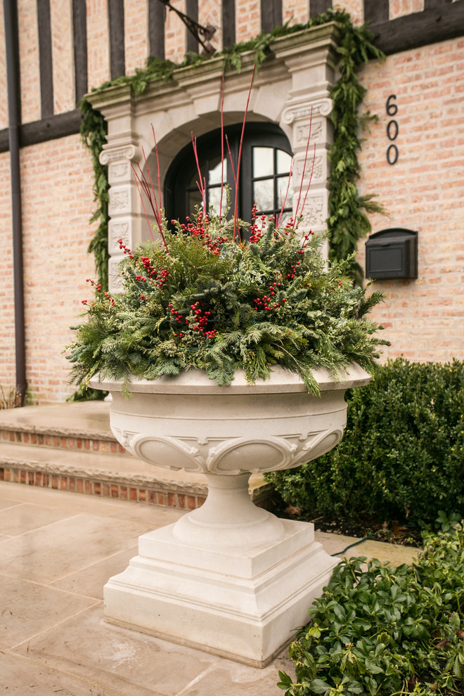 Esempio di un grande giardino tradizionale esposto in pieno sole davanti casa in inverno con un giardino in vaso e pavimentazioni in pietra naturale