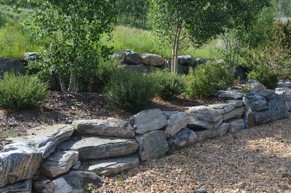 Design ideas for a huge partial sun stone water fountain landscape in Denver for summer.