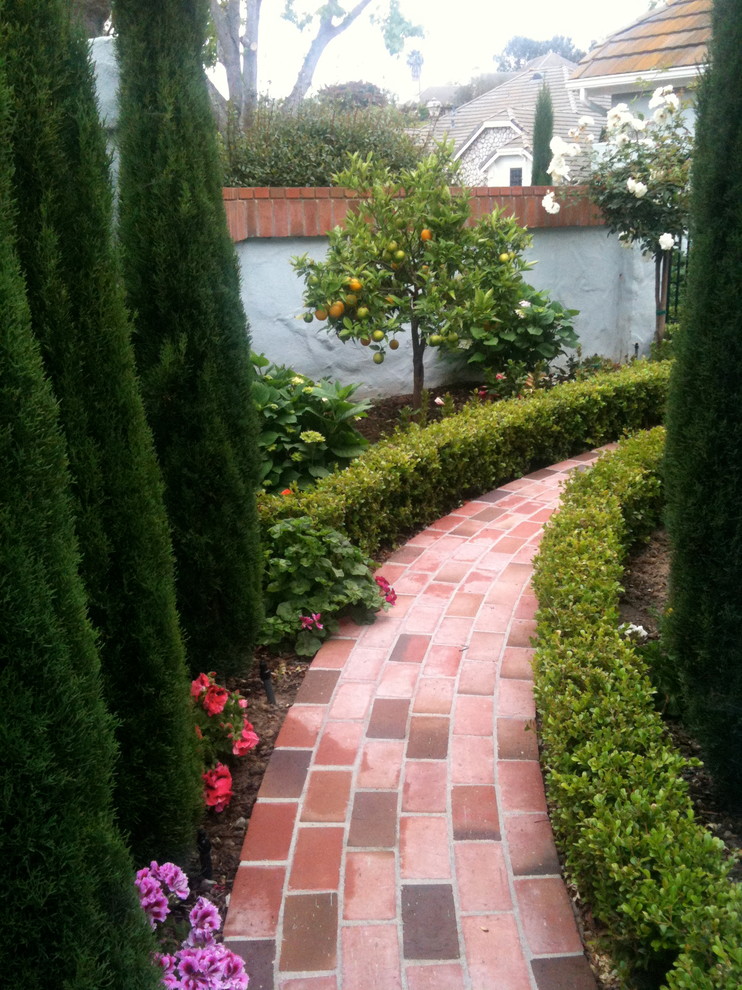 Photo of a traditional partial sun side yard brick landscaping in San Diego.