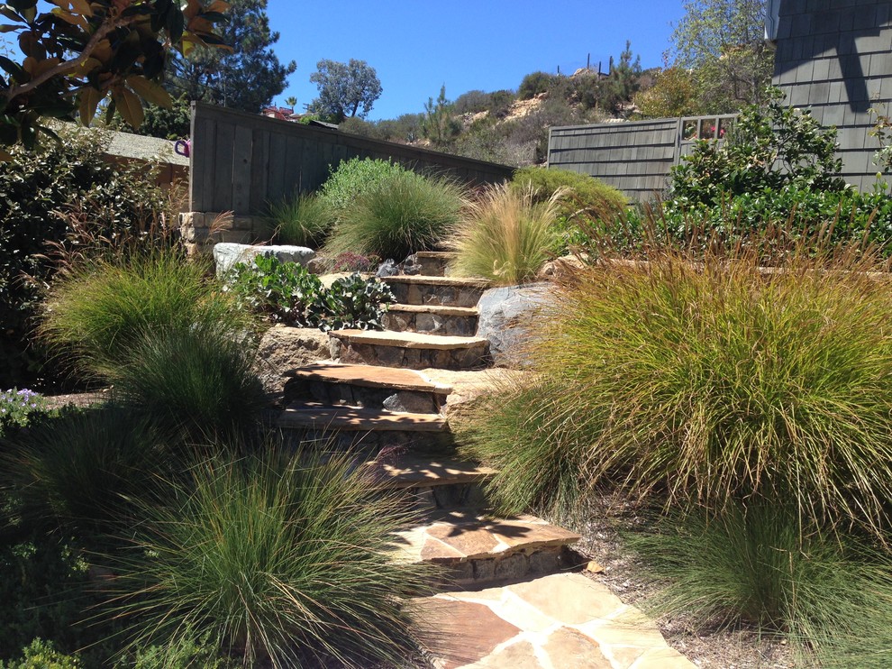Photo of a craftsman drought-tolerant and full sun backyard stone landscaping in San Diego.