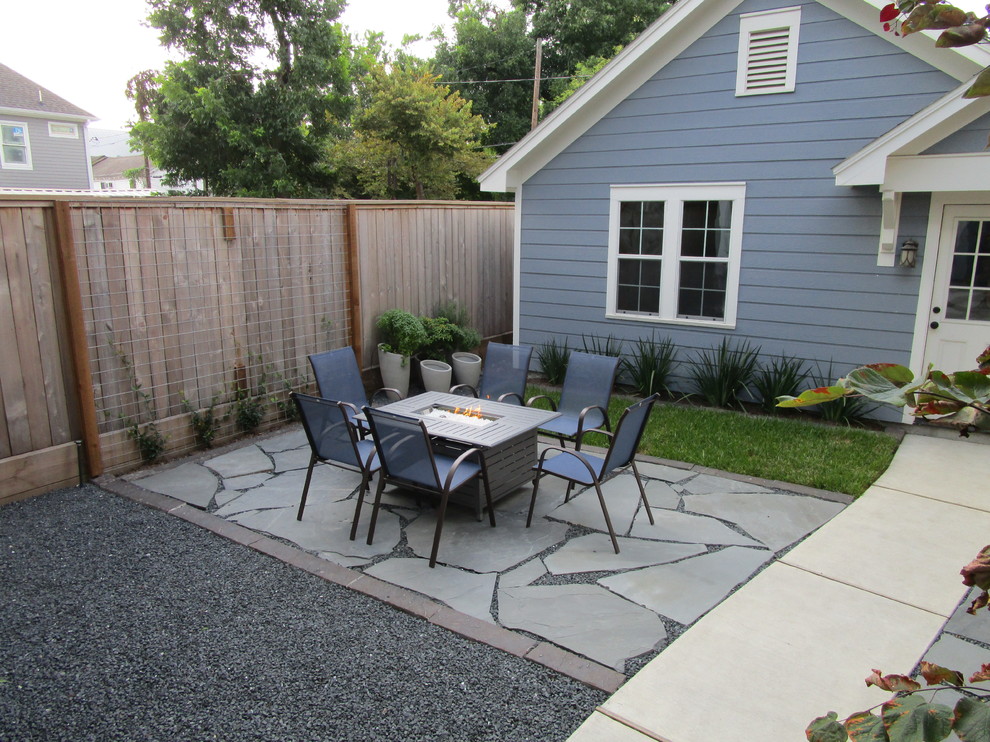 Inspiration for a small modern back patio in Houston with a living wall and natural stone paving.