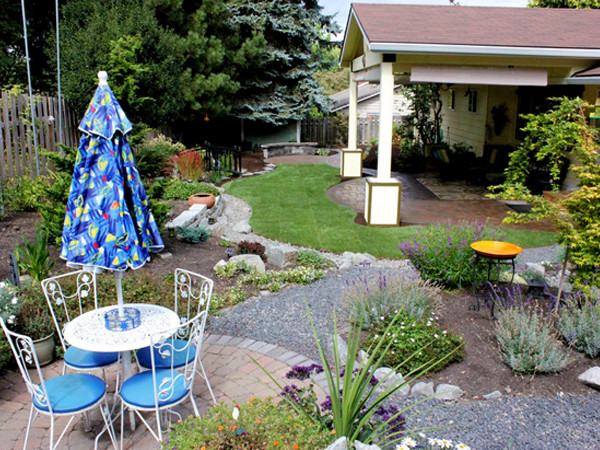 Design ideas for a mid-sized eclectic full sun backyard gravel garden path in Portland for summer.