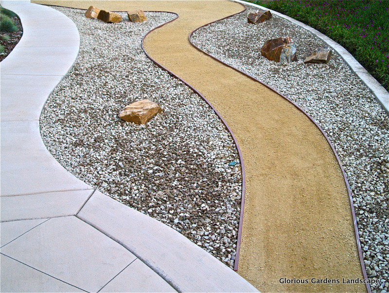 This is an example of a mid-sized full sun backyard gravel landscaping in San Diego.