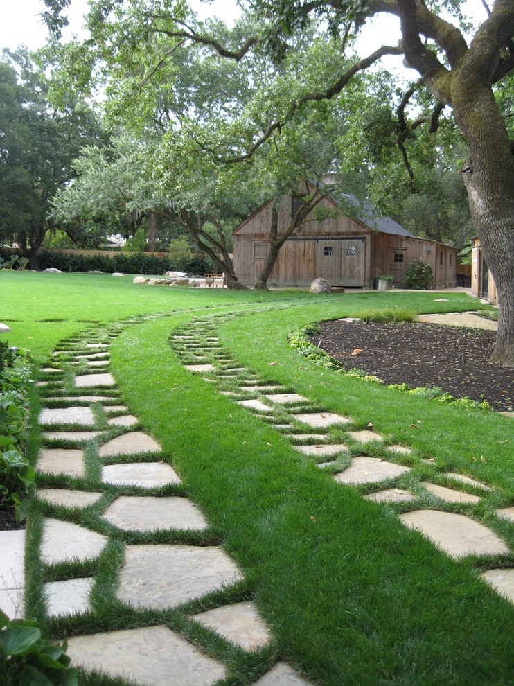 This is an example of a farmhouse back driveway garden in San Francisco with natural stone paving.