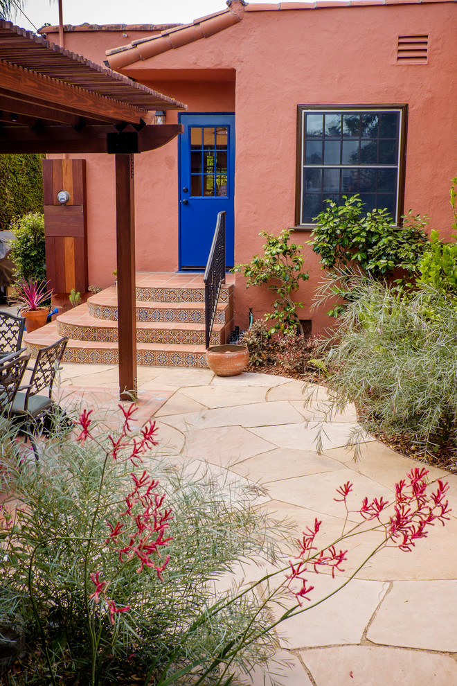 This is an example of a mid-sized mediterranean partial sun backyard stone formal garden in Los Angeles for spring.