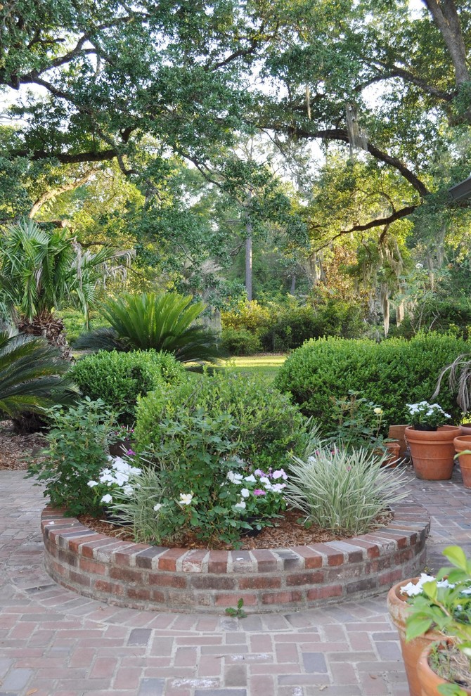 Design ideas for a farmhouse back formal garden in New Orleans with a garden path and brick paving.