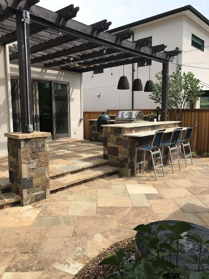 Patio - mid-sized traditional backyard stone patio idea in Denver with a fireplace