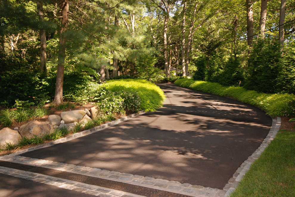 Traditional driveway fully shaded garden in New York.