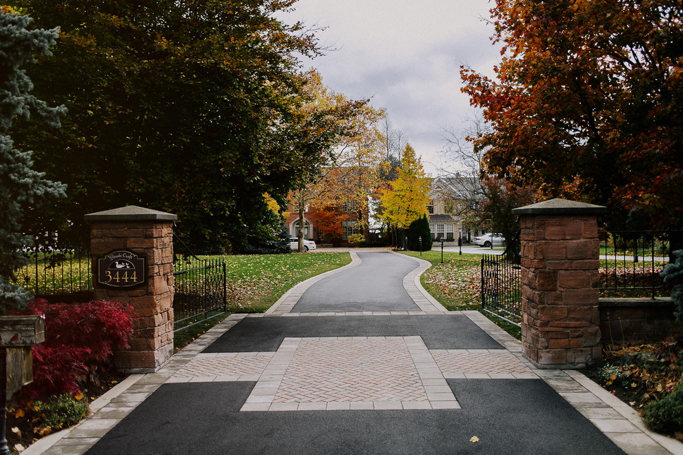 Idee per un grande vialetto d'ingresso tradizionale esposto a mezz'ombra davanti casa in autunno con pavimentazioni in mattoni