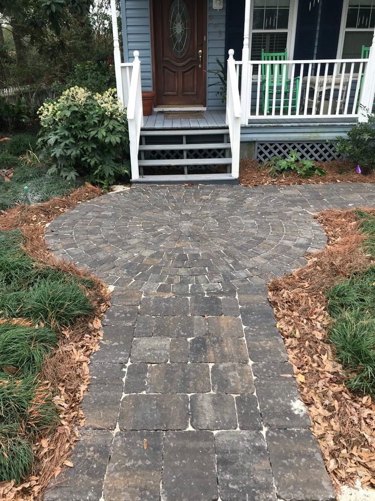 This is an example of a small classic front formal garden in Charleston with a garden path and concrete paving.