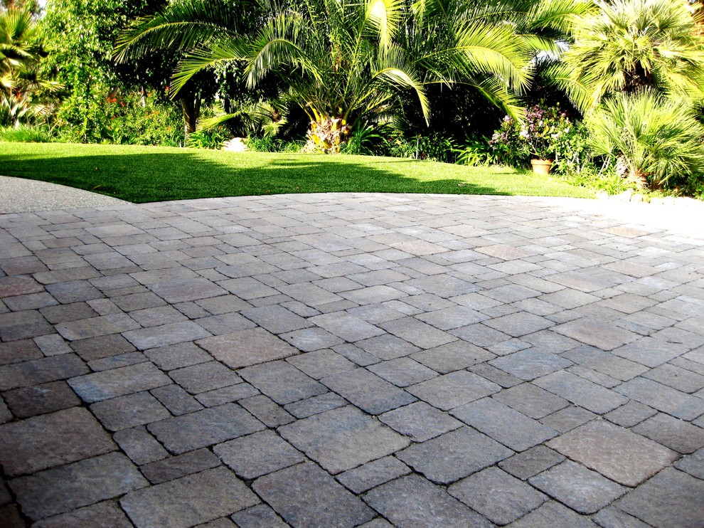 Medium sized traditional front driveway partial sun garden in New York with brick paving.