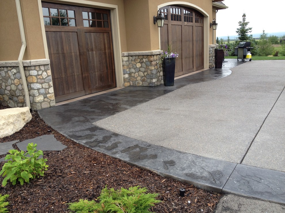 Photo of an expansive modern front driveway garden in Calgary with concrete paving.