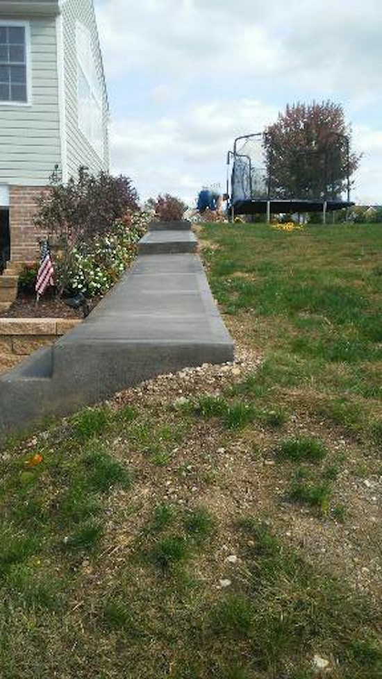 Photo of a medium sized traditional side full sun garden in Other with concrete paving.