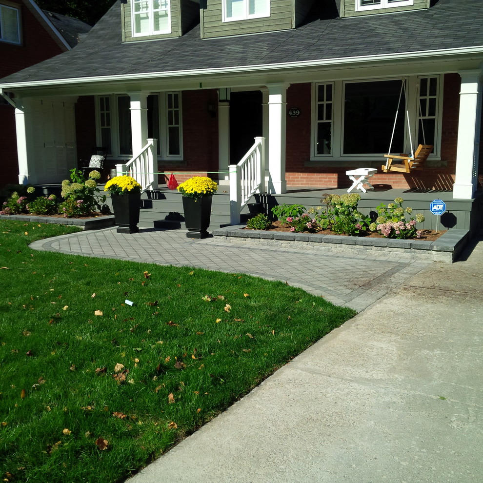 Design ideas for a large traditional full sun front yard driveway in Toronto.