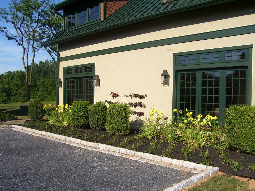 Photo of a traditional driveway garden in Philadelphia with gravel.