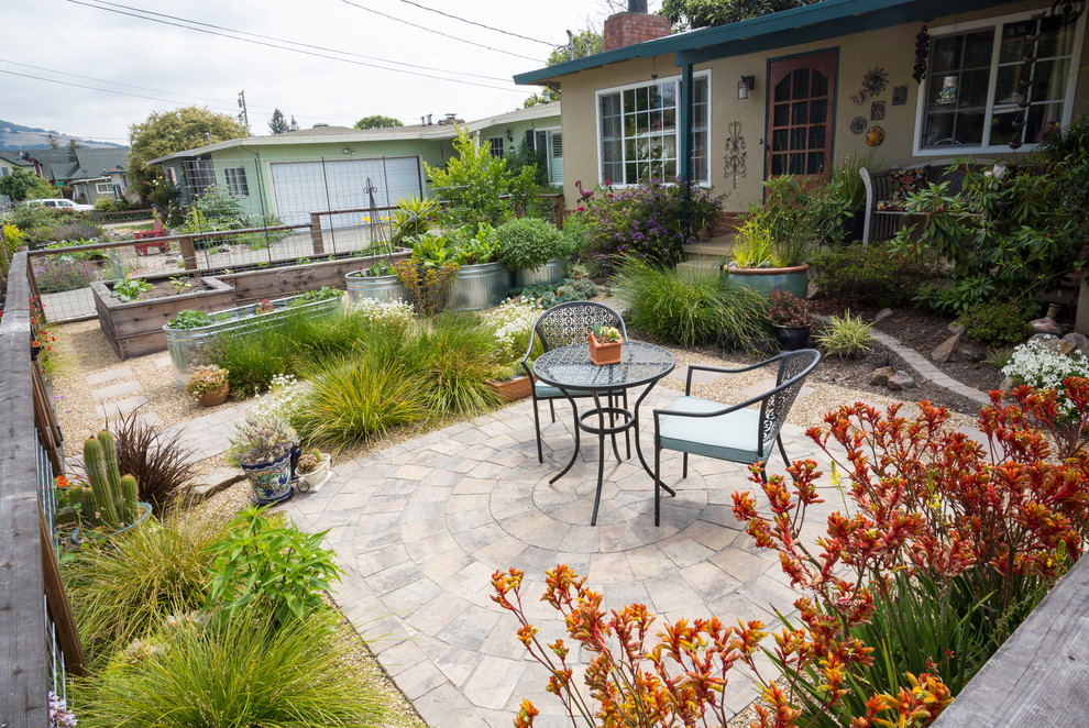 This is an example of a medium sized mediterranean front full sun garden in San Francisco with a vegetable patch and concrete paving.