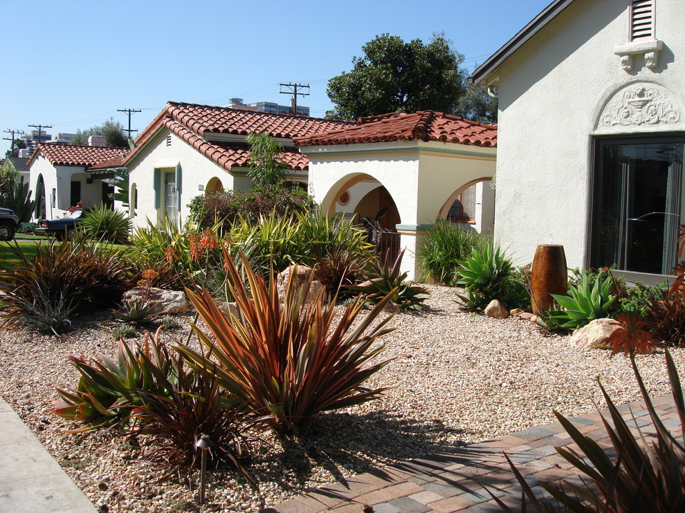 Design ideas for a mid-sized southwestern drought-tolerant and full sun front yard concrete paver landscaping in Los Angeles.
