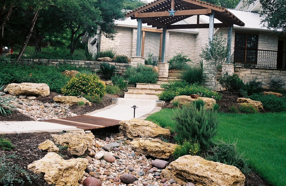 Inspiration for a large rustic back partial sun garden for spring in Austin with concrete paving.