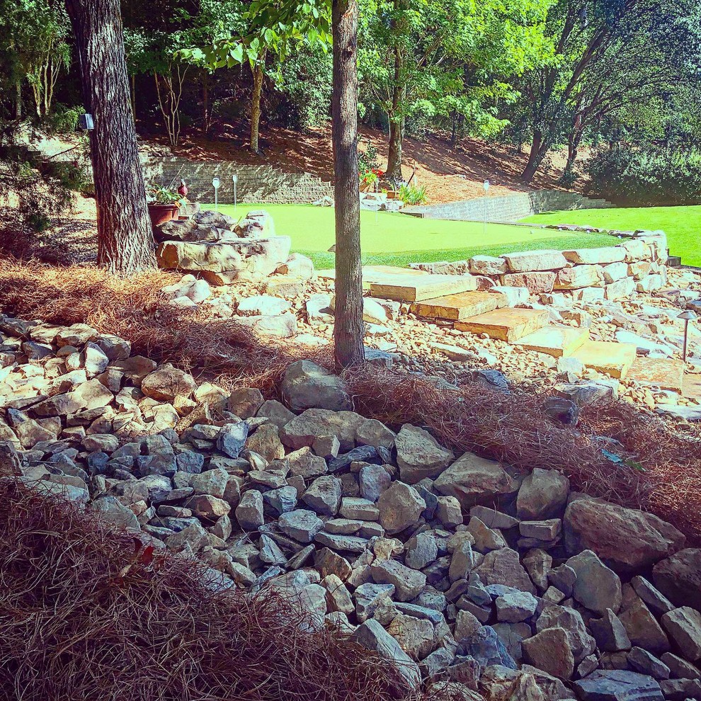 This is an example of a traditional rock backyard river rock landscaping in Birmingham.