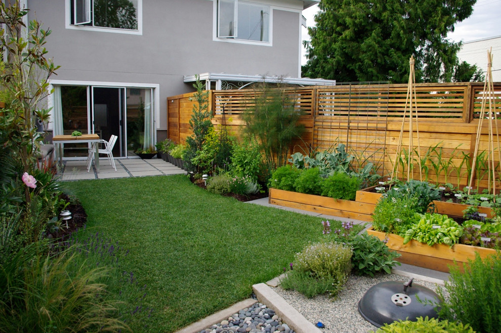 Photo of a contemporary backyard vegetable garden landscape in Vancouver.