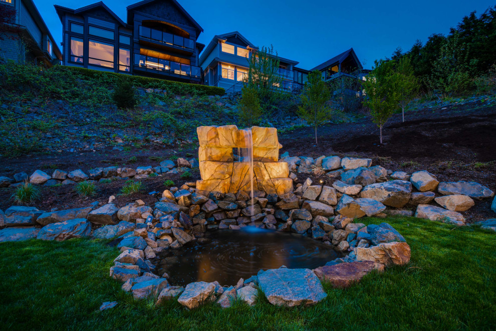 Photo of an expansive contemporary back garden in Vancouver with a waterfall.