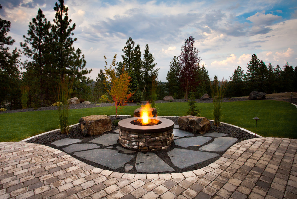 This is an example of a traditional backyard landscaping in Seattle with a fire pit.