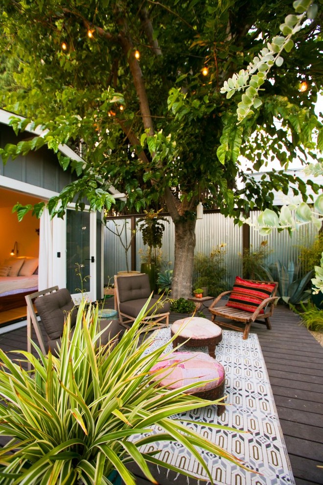 This is an example of a mid-sized eclectic partial sun backyard landscaping in Los Angeles.